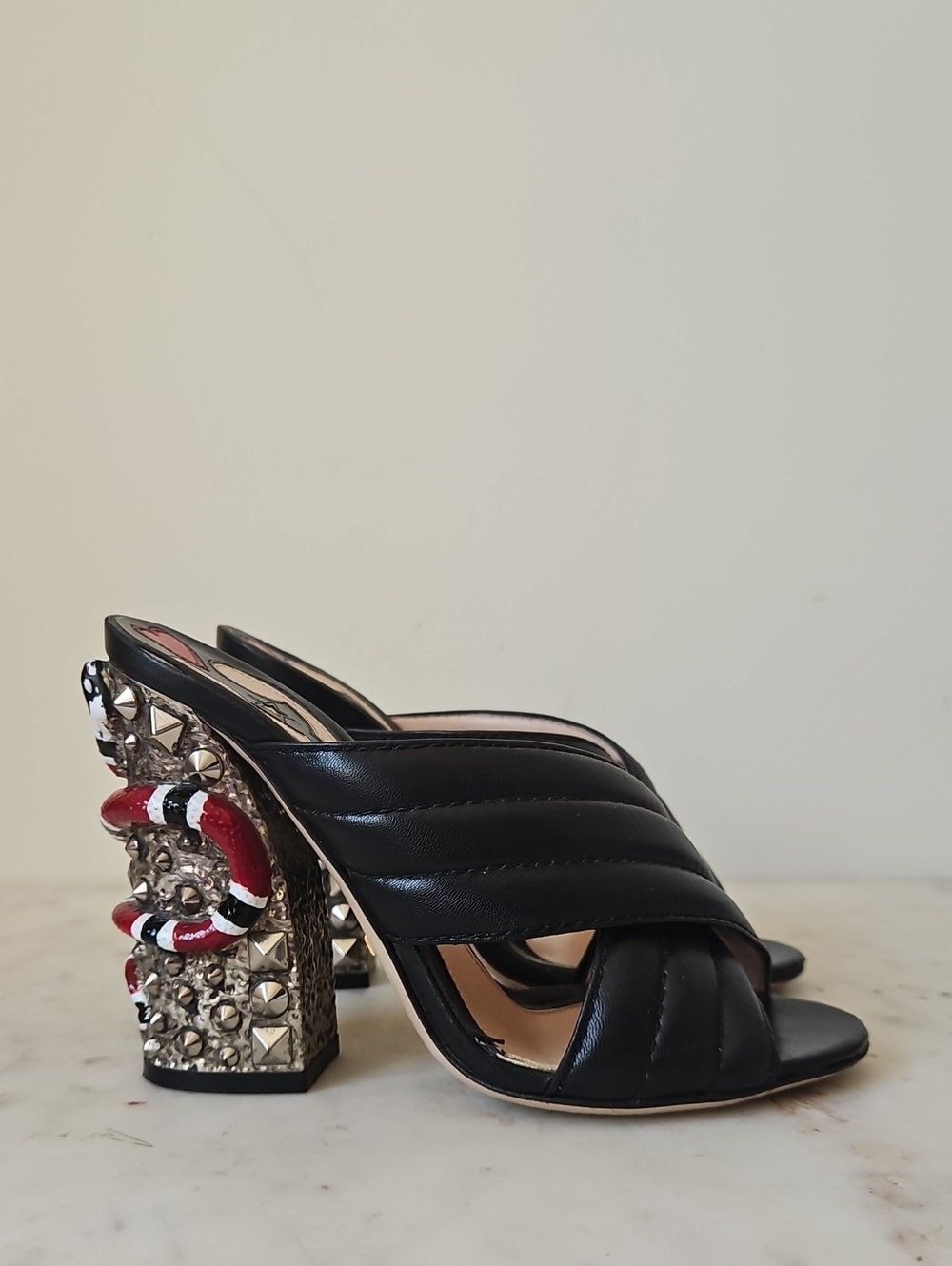 GUCCI: Black Quilted Leather Webby Sculptural Snake Heels